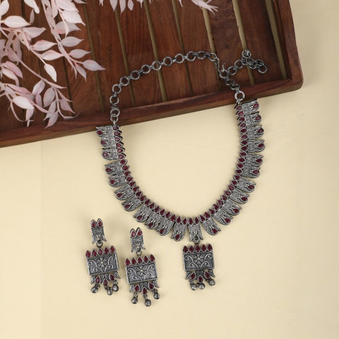 Tribal Oxidized Silver-Plated Necklace Set Featuring Red Stone Embellishments and Dangling Drop Earrings